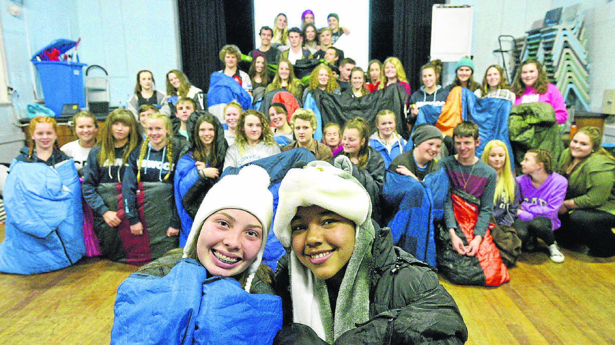 SNUGGLING UP:  St Joseph’s year 9 students Mykenzie Rowe and Triana Stellenberg and their classmates took part in a sleep out to raise their awarenss of ­homelessness.  	Picture by STUART SCOTT