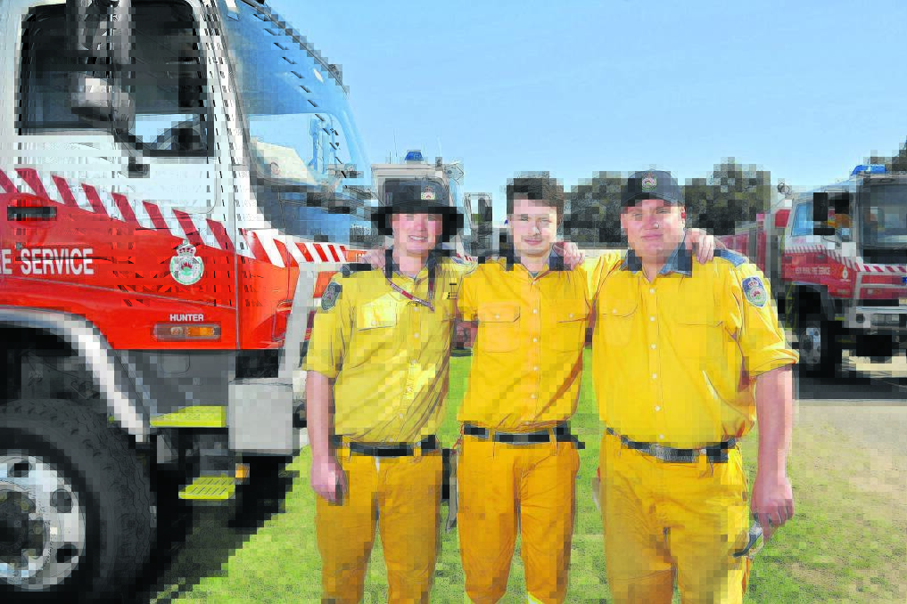 IN THEIR HANDS:  Lochinvar Rural Fire Service members Daniel and Nicholas Crowther with Sean Carman. 	Picture by PERRY DUFFIN