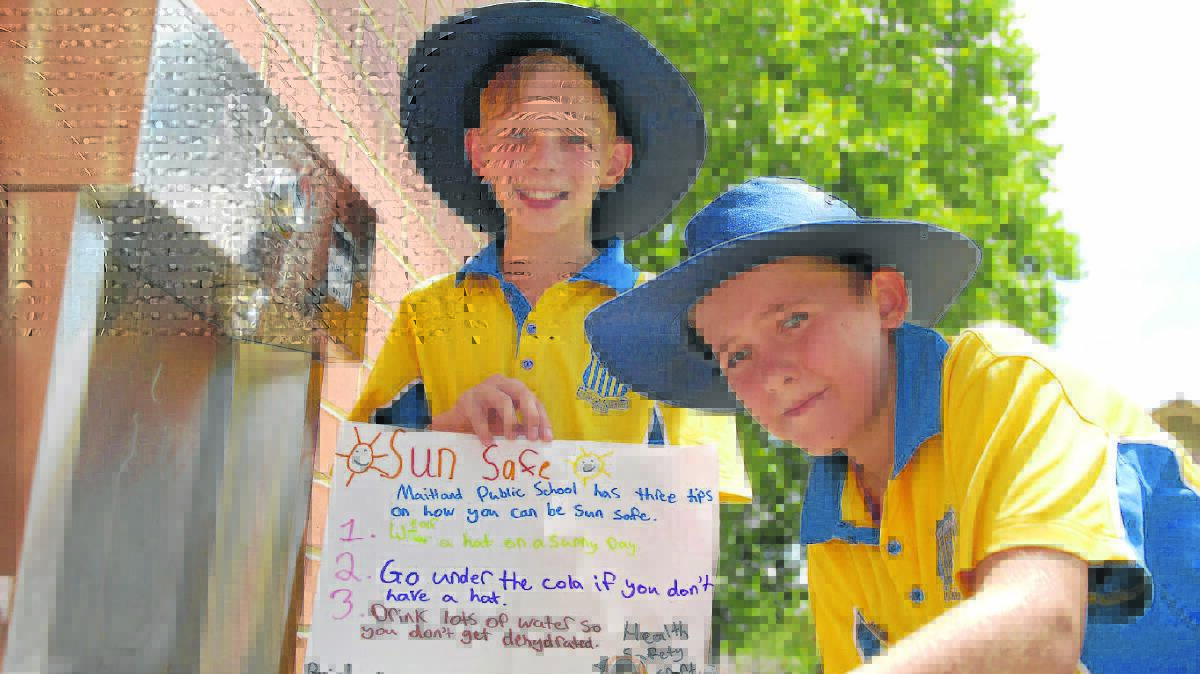SAFETY MESSAGE: Lachlan Martin and Jordan Tunua with their sun safety message for Maitland Public School students. 	Picture by SAM NORRIS