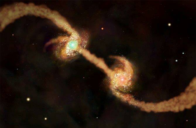 Collision course: Colliding galaxies with super massive black holes form elliptical galaxies. Credit: NASA/CXC/M.Weiss.