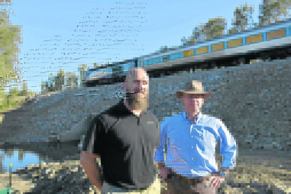 Australian Rail Track Corporation's Peter Hodgson and Brigadier Darren Naumann inspect the repaired rail line at Tocal.