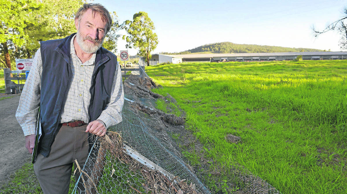 HEAVY LOSSES: Tocal Agricultural Centre manager Basil Gijsbers inspects damaged fences  near the poultry sheds.  	Picture by STUART SCOTT 120515SS100