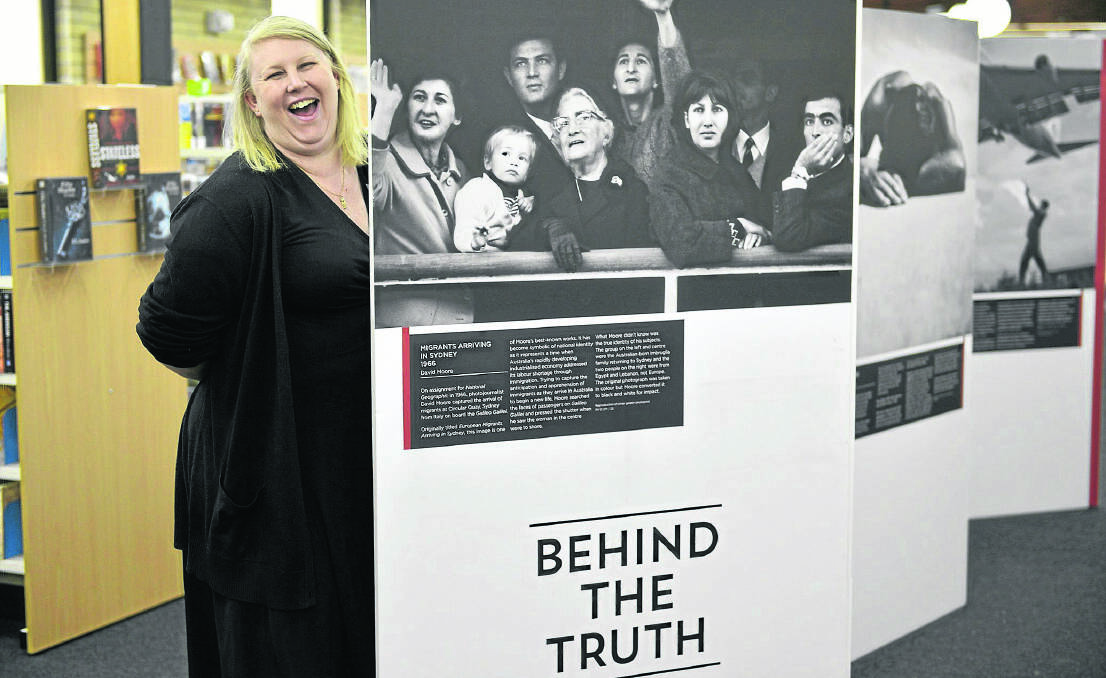Maitland Branch librarian Maggie Leayr with the Behind the Truth display which runs until January 16.  