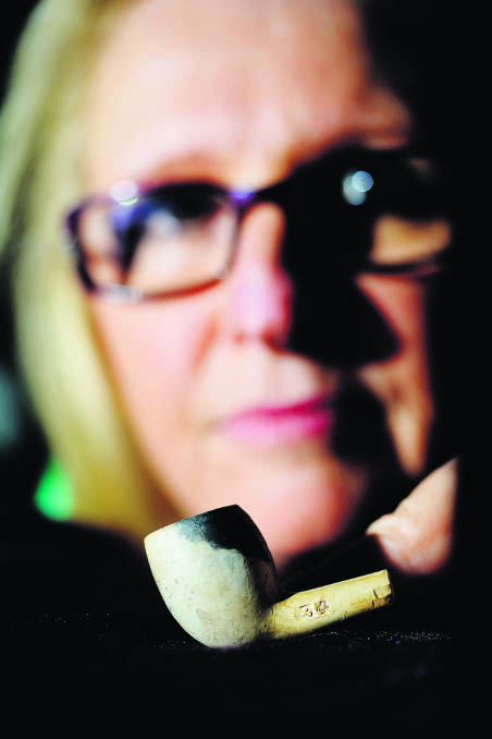 EXCITEMENT:  Julie Hvirf with the clay pipe found in her back yard.
 	Picture by STUART SCOTT 120614SS205 