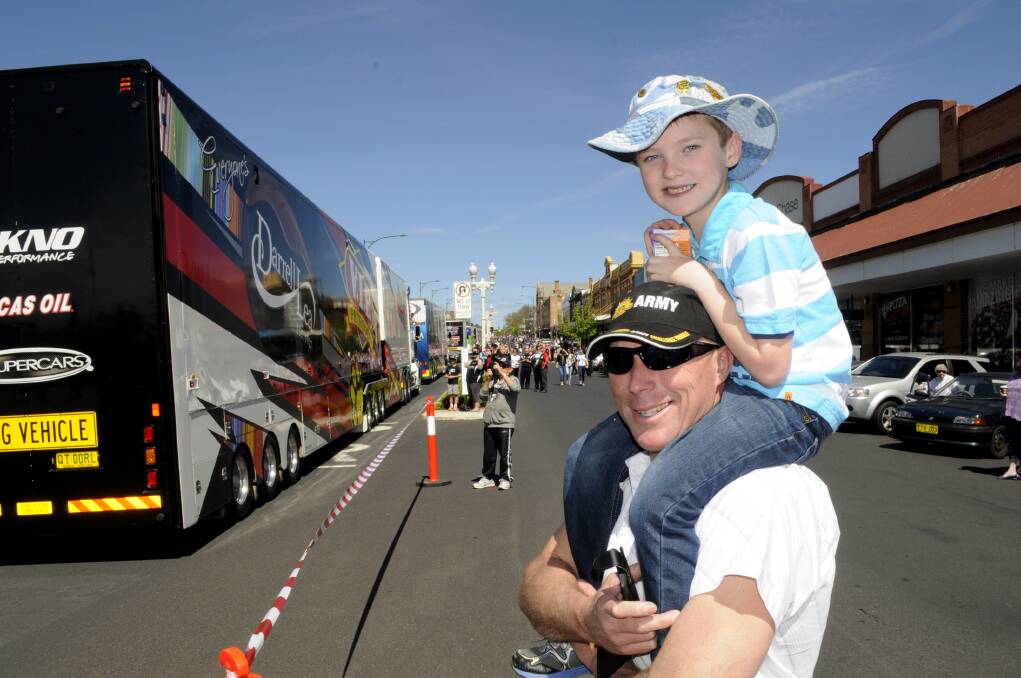 BACK ON TRACK: The driver parade will return to the Bathurst 1000 Race Week off-track events this year. Matt Priestley celebrated his son Will’s seventh birthday during the 2014 event. Photo: CHRIS SEABROOK 	100814ctruks17