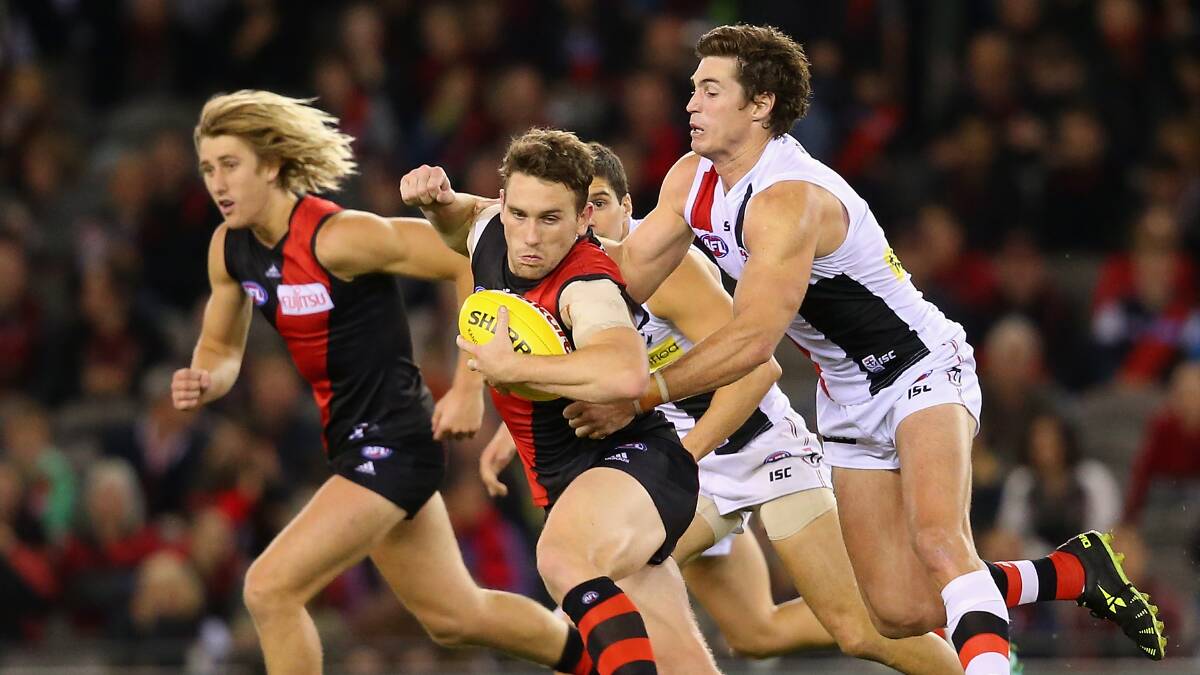  Heath Hocking of the Bombers is tackled by Lenny Hayes of the Saints during the round five AFL match between the Essendon Bombers and the St Kilda Saints at Etihad Stadium on April 19, 2014 in Melbourne, Australia. Photo: Quinn Rooney/Getty Images.