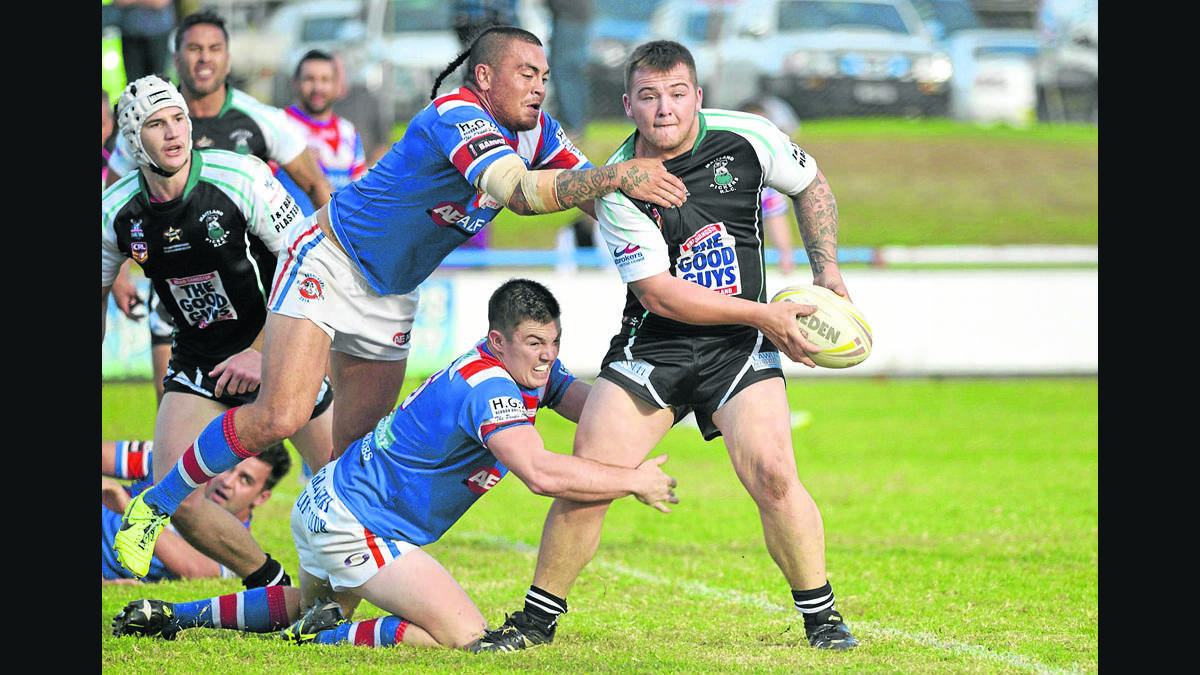 TOUGH MATCH:  Two Bulldogs latch on to Pickers ­player Tylar Carter.
