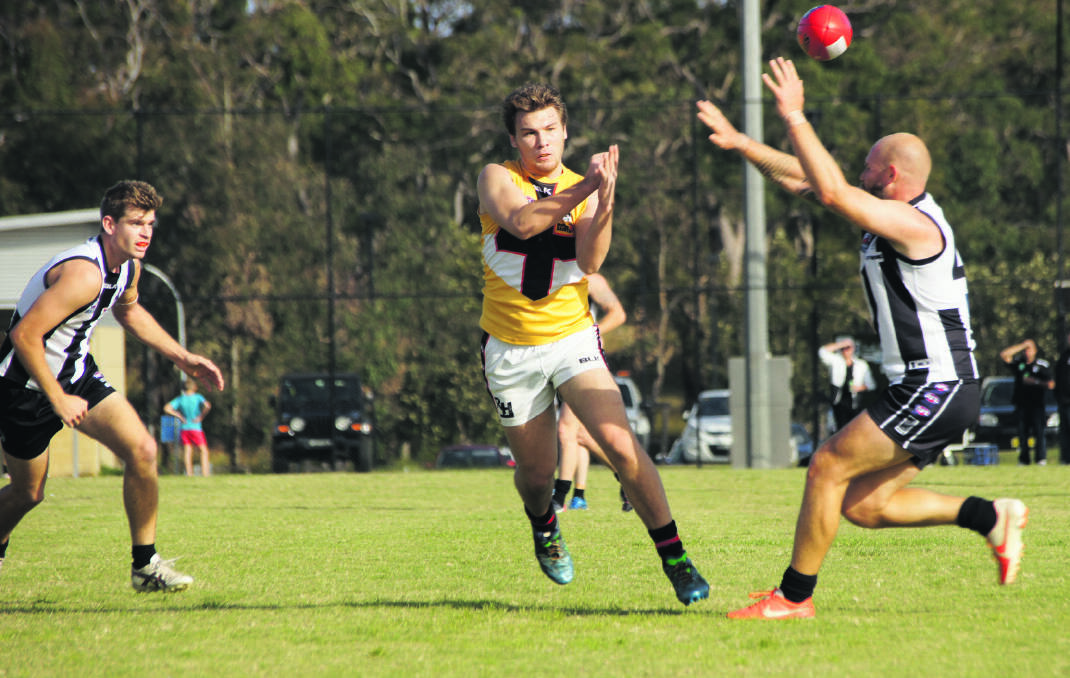 Maitland Saints midfielder Aidan Broadway clears the ball before being tackled. Picture by RICK MERRICK