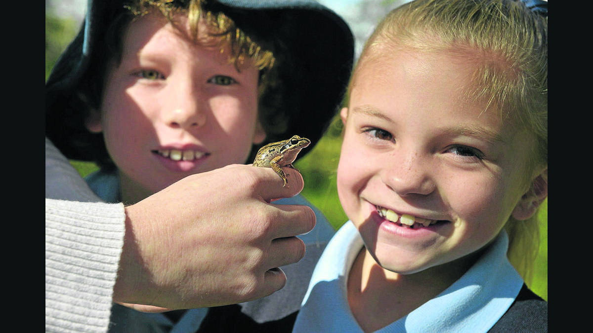 GETTING CLOSER TO NATURE:  Morpeth Public School students Billy Lockood and Ruby McGill with a little friend at Earthcare Park Tenambit.    