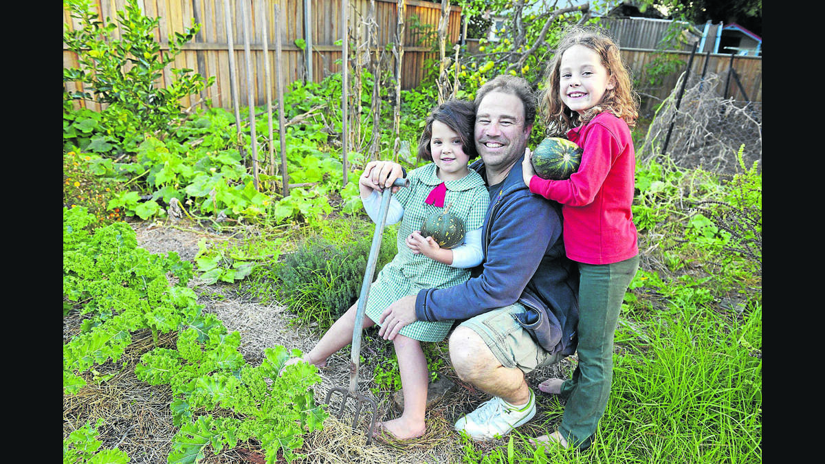 COMMUNITY SPIRIT:  Matthew Hill, with his daughters Poppy and Charley, is part of a push to establish a community garden in Lorn.  	Picture by STUART SCOTT 