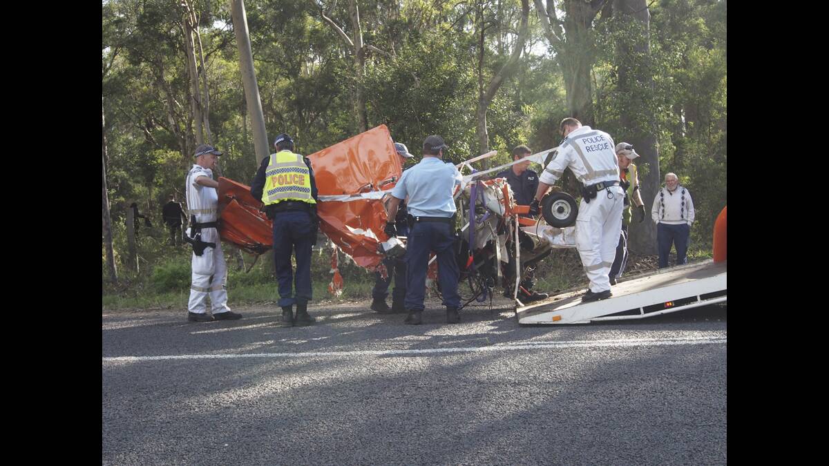 TRAGEDY:  The remains of the plane are removed from the paddock by police yesterday.   	Picture by NICK BIELBY