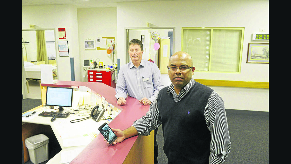 OFF LINE:  Dr Aijaz Majeed, who has been forced to use his mobile phone, with hospital CEO Brett Dennett.  