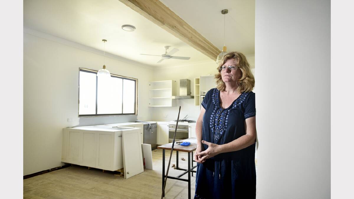 Kathryn Wittmann in the shell of her house which she hopes will be livable very soon. Photo by Perry Duffin
