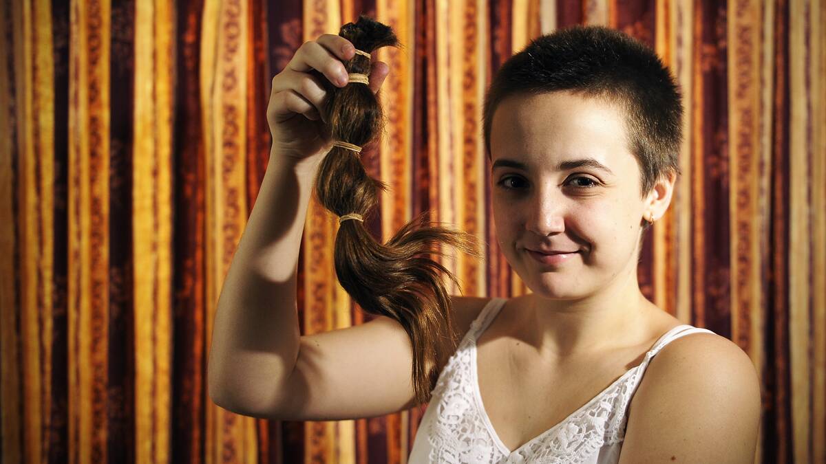 East Maitland teenager Maddison Teat with the ponytail she shaved off in honour of her mother as part of a Bowel Cancer Australia fundraiser.