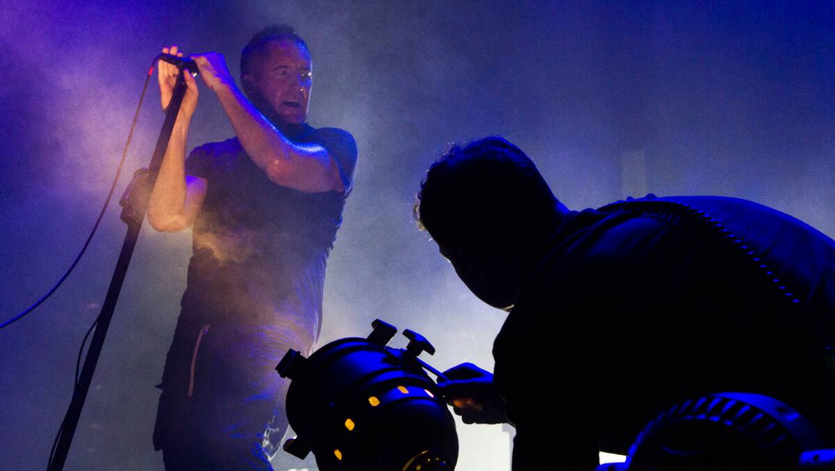 NAILING IT: Nine Inch Nails vocalist Trent Reznor uplit by a lighting technician. Picture by KEVIN BULL