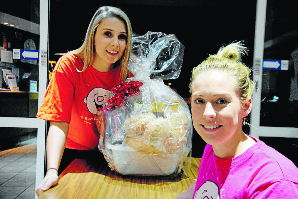 GOOD CAUSE:  Teagan Luckner and Rhiannon Varley with some of the prizes that people can win at the Christmas in July Ball at Telarah Bowling Club.  	Picture by SAM NORRIS