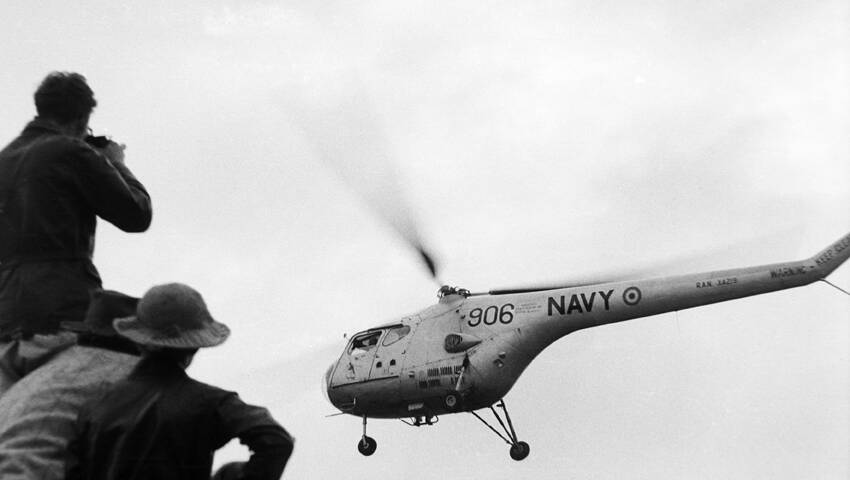 TRAGEDY: Two men died when this
helicopter crashed into floodwaters during the 1955 Maitland flood.