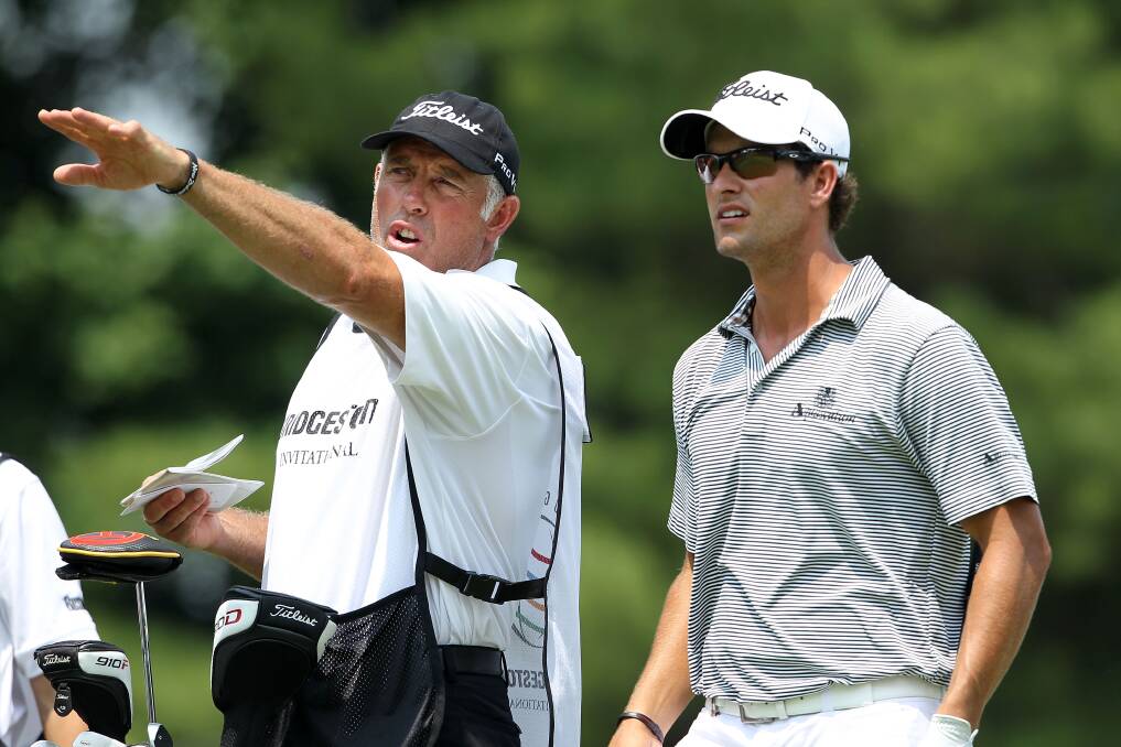 HONOURABLE PROFESSION: Caddie Steve Williams discusses a shot with Australian golfer Adam Scott in 2011. The pair have since parted ways, with Williams looking to cut back his touring to spend more time with his family.