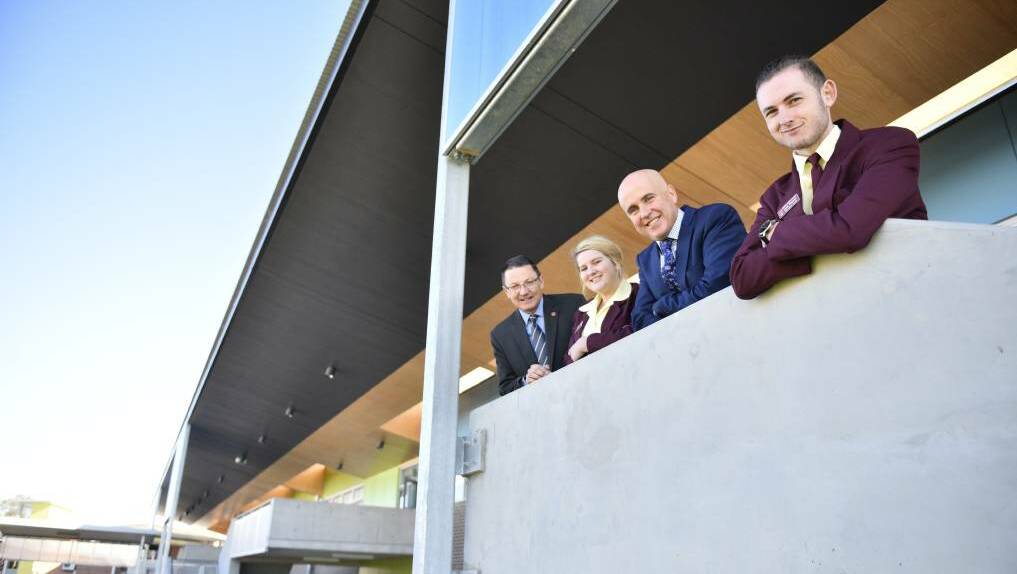 NSW education minister Adrian Piccoli (second from right) opening upgrades to Rutherford Technology High in June with Parliamentary Secretary for the Hunter Scot MacDonald and students Melissa Travis and Liam Faustini. Picture: PERRY DUFFIN