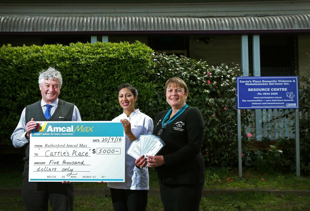 Funding boost: Amcal Pharmacy Rutherford owner Guy McKendry and manager Caroline Enright with Carrie's Place representative Jenny Harland. Picture: Marina Neil