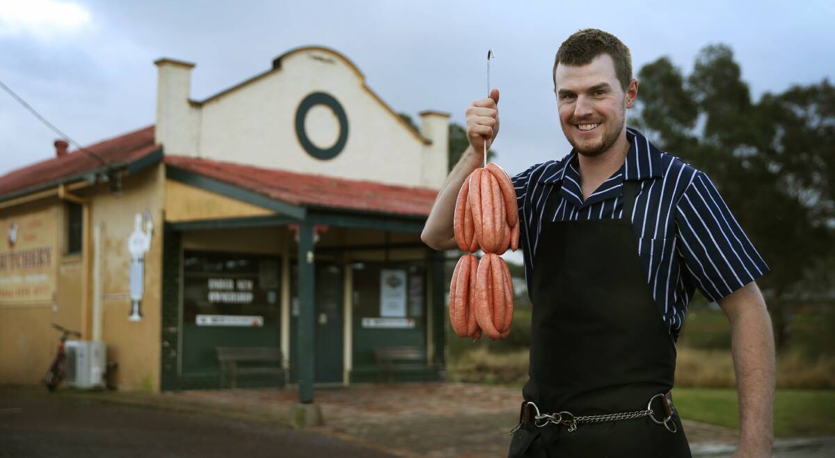 CHAMPION: Clarence Town butcher Ethan Patfield holds his award winning snags. Picture: MARINA NEIL 