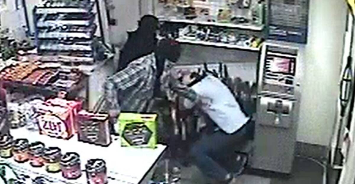 DEFENCE: The other armed robbers join in on the attack of the attendant, who emerged from the back room with a broom to defend the store. Picture: Supplied