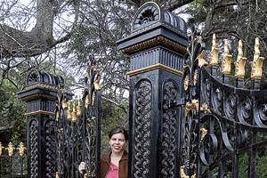 HAVE A GO:  Maitland City Council heritage officer Clare James with the restored Shenstone gates at Bolwarra. 