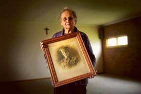 REMEMBERED:  Heather Yates holds the portrait of Corporal Sam Robinson.  