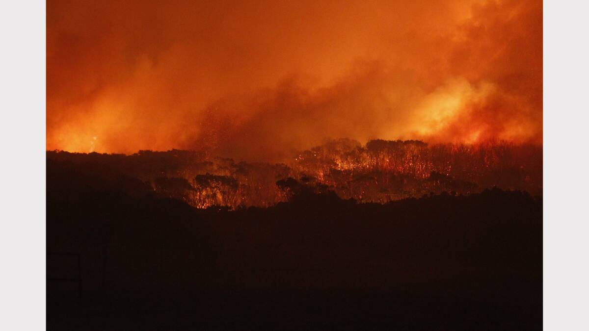 Scenes from the fire at Catherine Hill Bay on Thursday night. Pictures by Jonathan Carroll