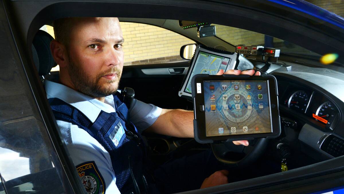 TECHNOLOGY LEAP:  Senior Constable Ben Fitzgerald is one of several Maitland police officers to trial the use of iPads in their day-to-day. duties.  