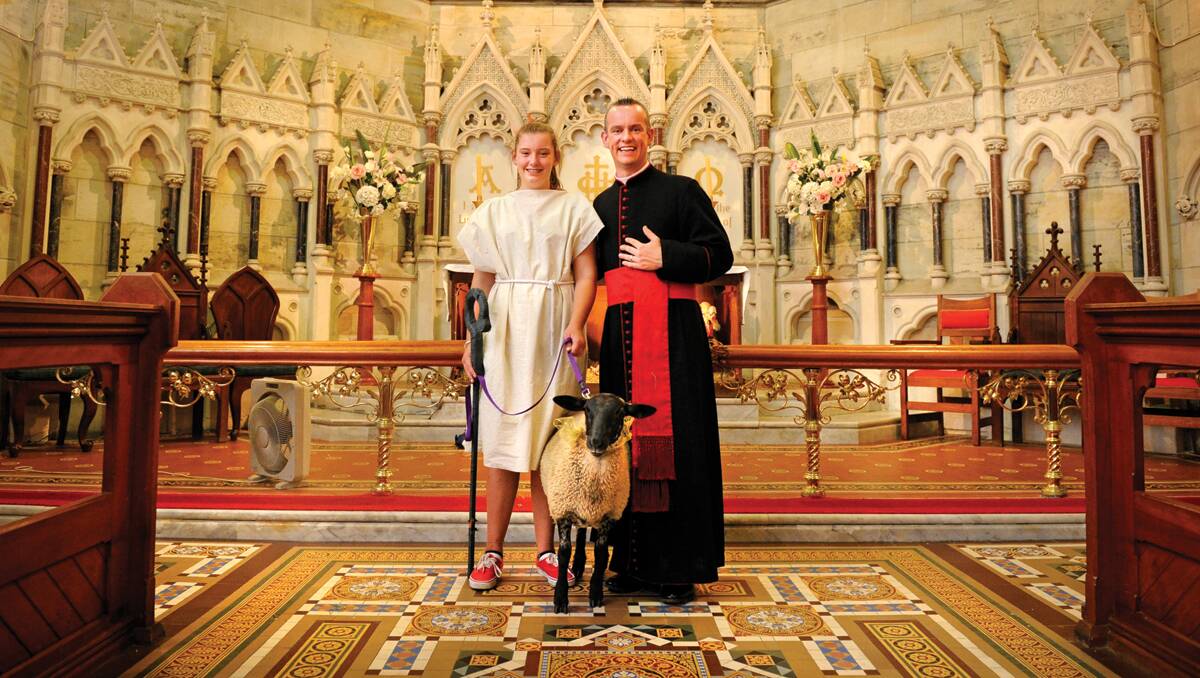 ALL CREATURES GREAT AND SMALL:  Father David Battrick with Olivia Wills and Willow the lamb. 
