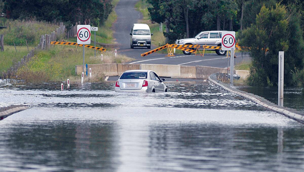 CAUGHT OUT:  An evacuated car , going nowhere until the water recedes at Testers Hollow.   