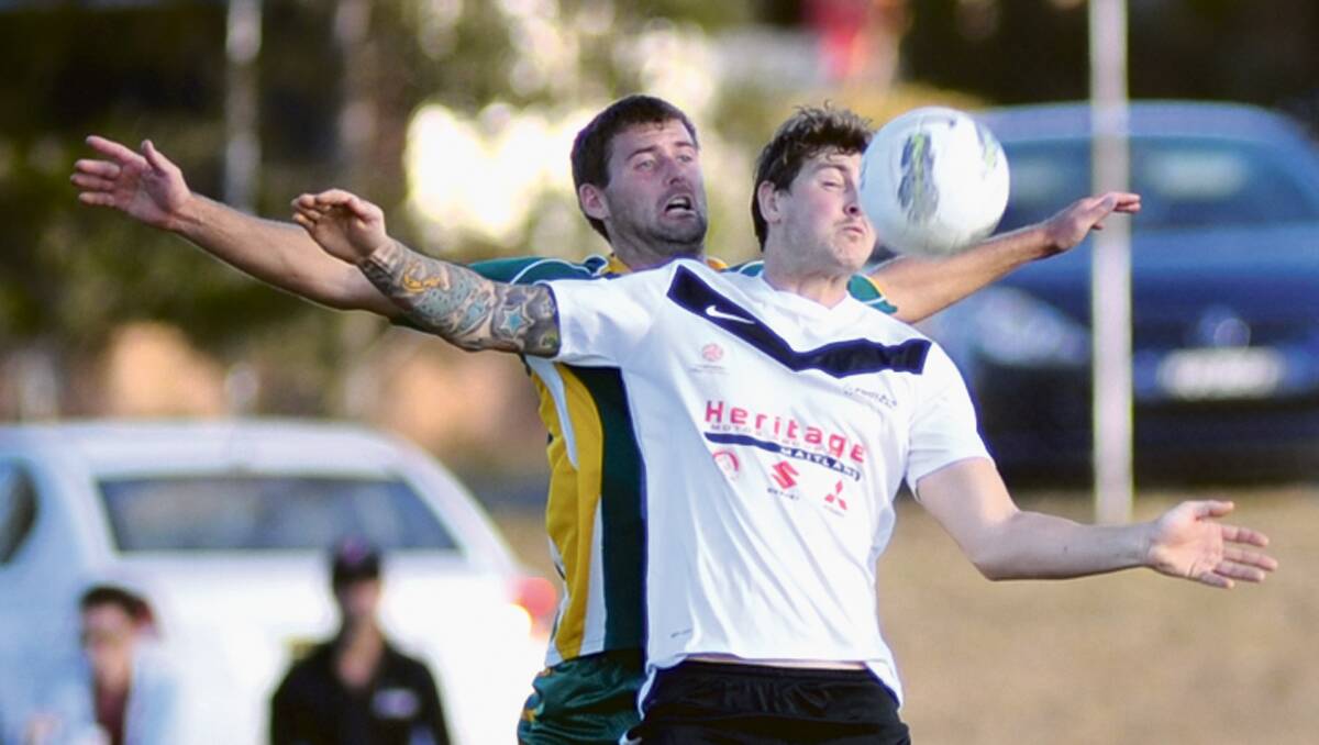 HEADED TO THE GRAND FINAL: Maitland striker Ben Martin wins the battle for the ball against Belmont Swansea.  