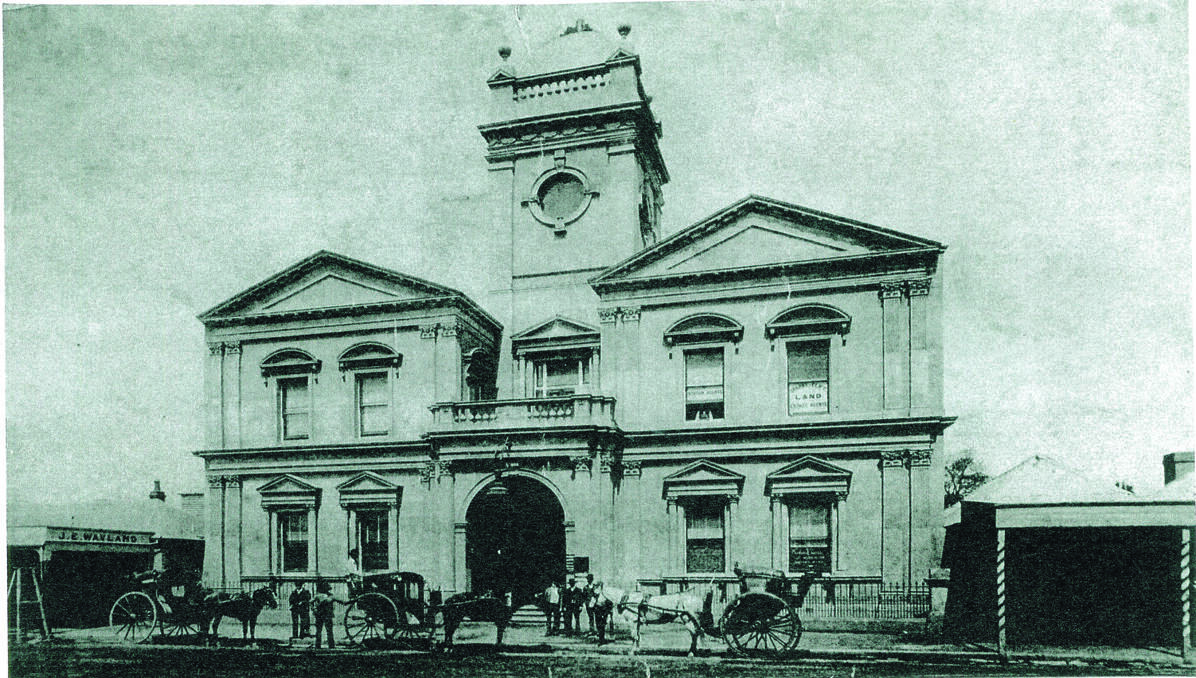 125 YEARS: Maitland Town Hall in its early days, with horses and buggies out front.