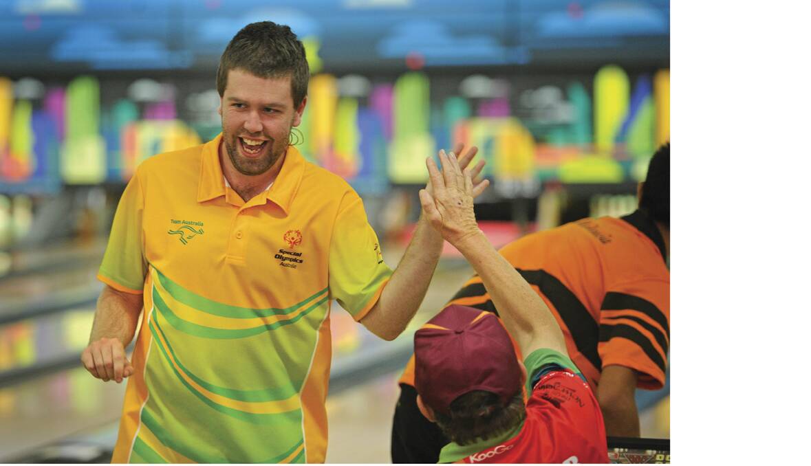 SPECIAL OLYMPICS: Aussie Luke Johnson gets a high five after a great shot.