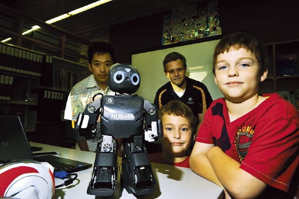 going robotic: Kenny Hong and Ryan Jeffery from the University of Newcastle with Oscar and Gus Baldick of Metford.    
