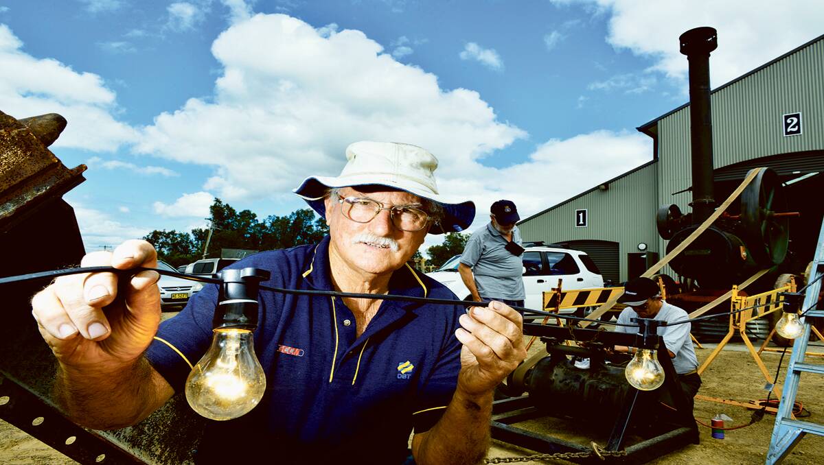 LET THERE BE LIGHT: Maitland Steam and Antique Machinery member Bob Neale uses a Marshall steam engine to power lights at the rally ground.   