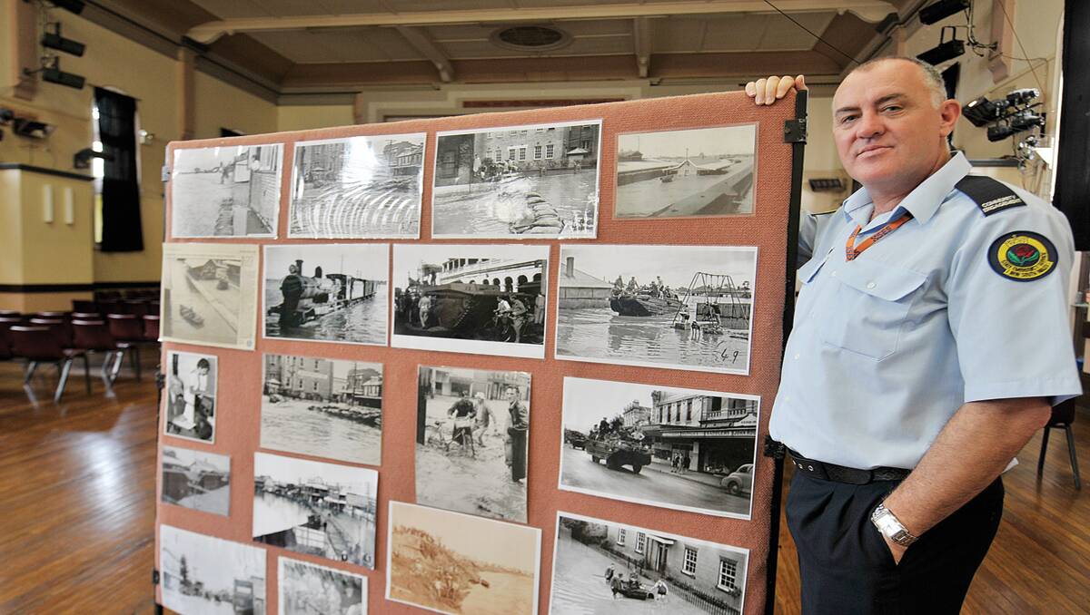 FLOOD DISPLAY:  Community engagement officer David Webb with images of the flood. 