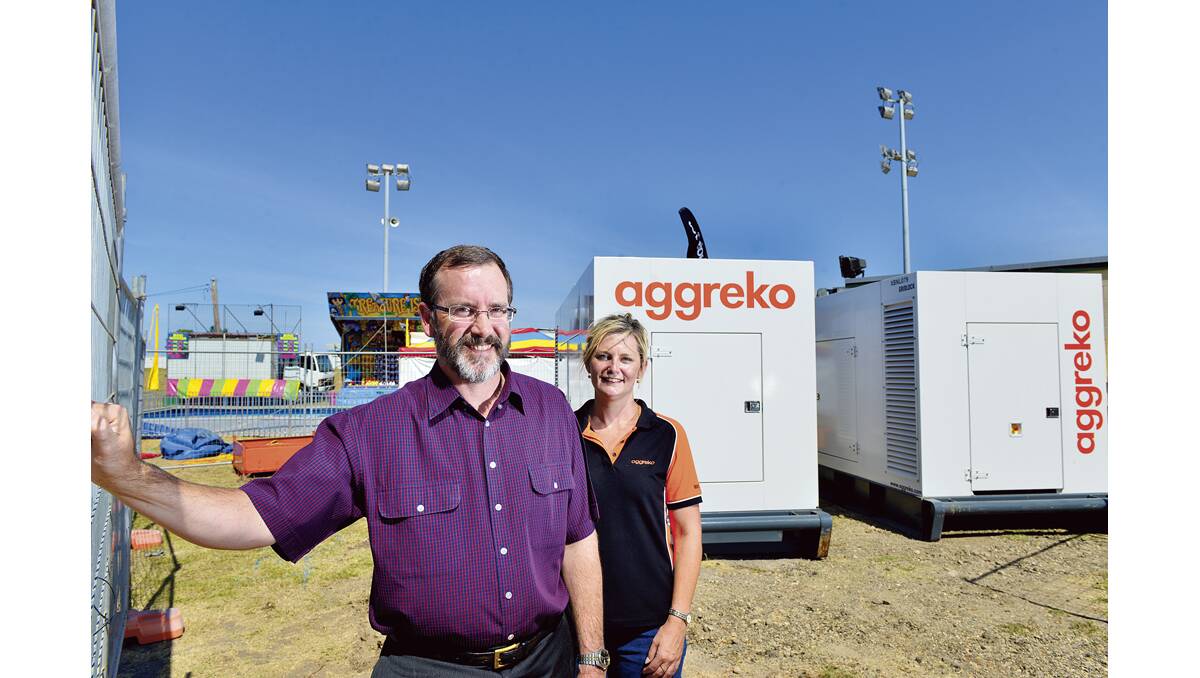 CUT THE BILL:  David Perrott with Aggreko sales consultant Trish Dodd with the new generators.  