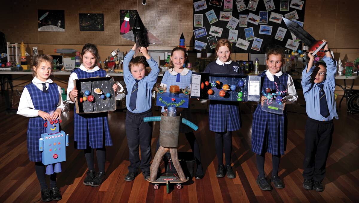 UNIVERSAL APPEAL: St Patrick’s Lochinvar students Abbey Parker, 7, Mia Soper, 7, Byron Kelly, 7, Tegan Cornish, 10, Cheyanne Murray, 11, Yasmin Hawkyard, 8, and Will Stores, 7, proudly display their award-winning artworks.  