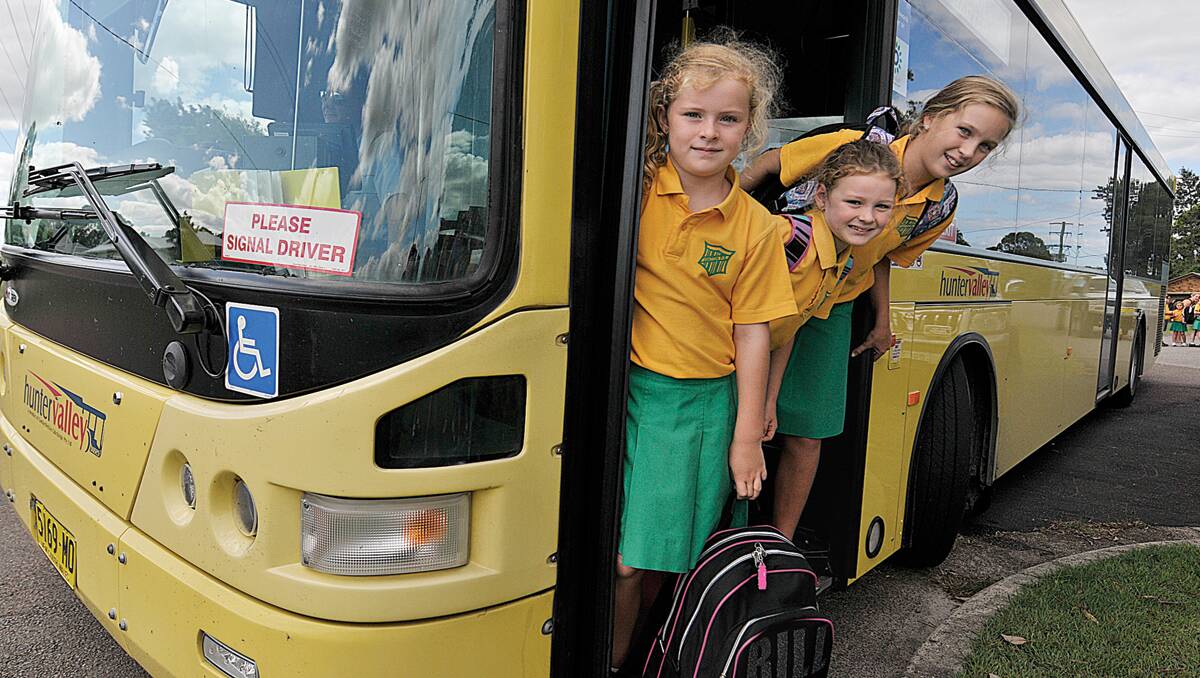 BACK TO SCHOOL:  Maddison Burton and Brigid Douglas, both from year 2, with Clare Douglas from year 6, catch the bus to Raymond Terrace.  
