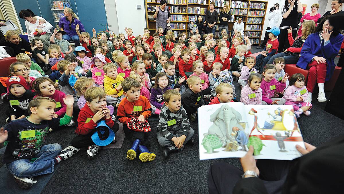 STORY TIME:  Councillor Robert Aitchison has a captive audience at Maitland City Library yesterday.   