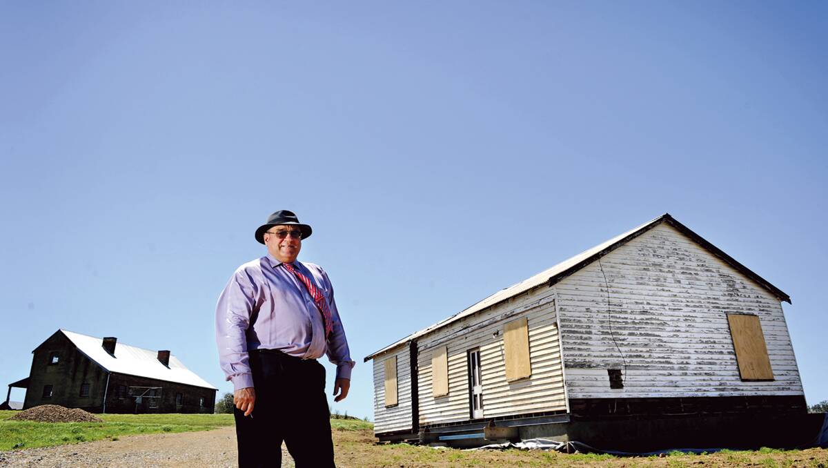 MOVED:  Dr Cameron Archer at the Daly Kidd cottage at Tocal which has been reinstated to its original site.  