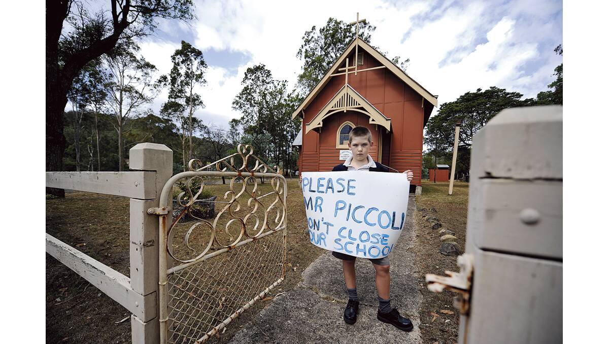 FIGHTING TO SAVE HIS SCHOOL: Martins Creek Public School student George Goulder, pictured at the local church.   	Picture by CATH BOWEN
