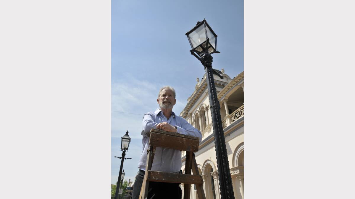 TOO GOOD TO LOSE:  Maitland heritage conservationist Chris Richards and the street lamps that are earmarked for removal.                                                                                                                      Picture by CATH BOWEN