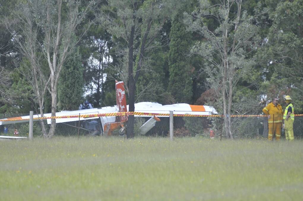 A light plane came to rest in trees just metres from a house