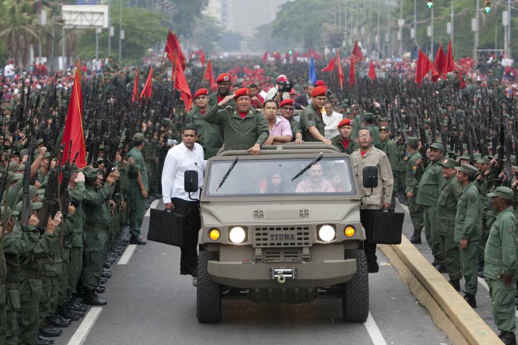 Venezuela's President Hugo Chavez salutes militia members as he arrives for a ceremony to commemorate the eighth anniversary of his return to power after a brief coup, in Caracas in April, 2010. Photo: REUTERS/Carlos Garcia Rawlins 