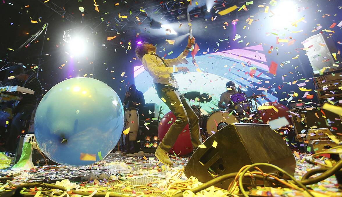 Flaming Lips singer Wayne Coyne turns the Falls Festival main stage into a rainbow.