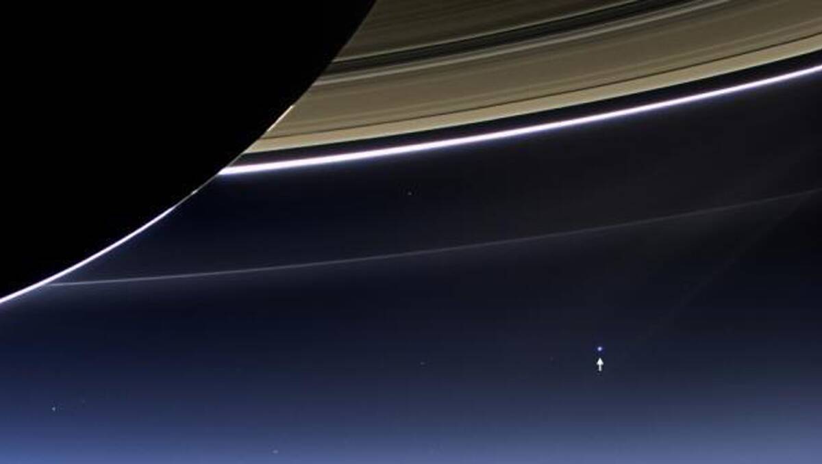 CASSINI SHOT: Earth is just a tiny spot in this stunning new image from NASA. 	Credit: NASA