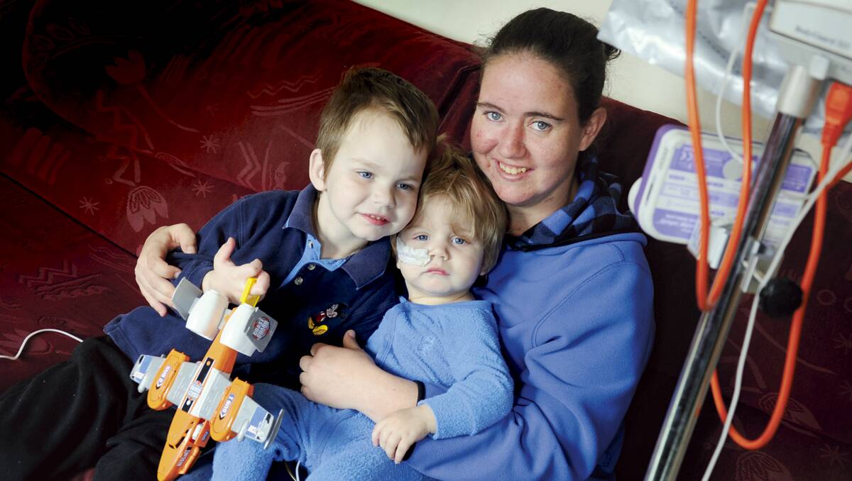 LOVING TOUCH: Brooke Walker with her sons Jordan, 4, (left) and Logan, 15 months. 	Picture: CATH BOWEN